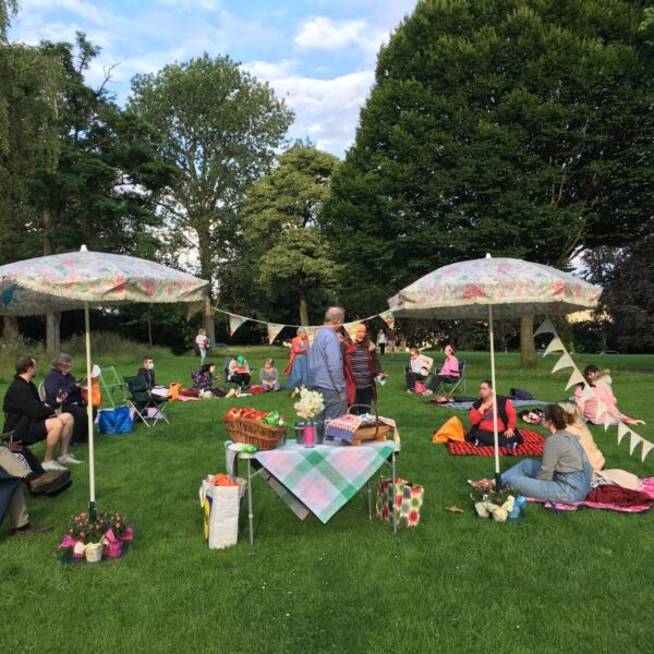 Group sat around on picnic blankets in the park