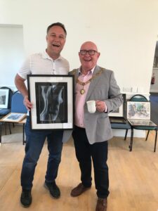 Photo of Mayor of Bath and Life Project CEO Rich holding an artwork 